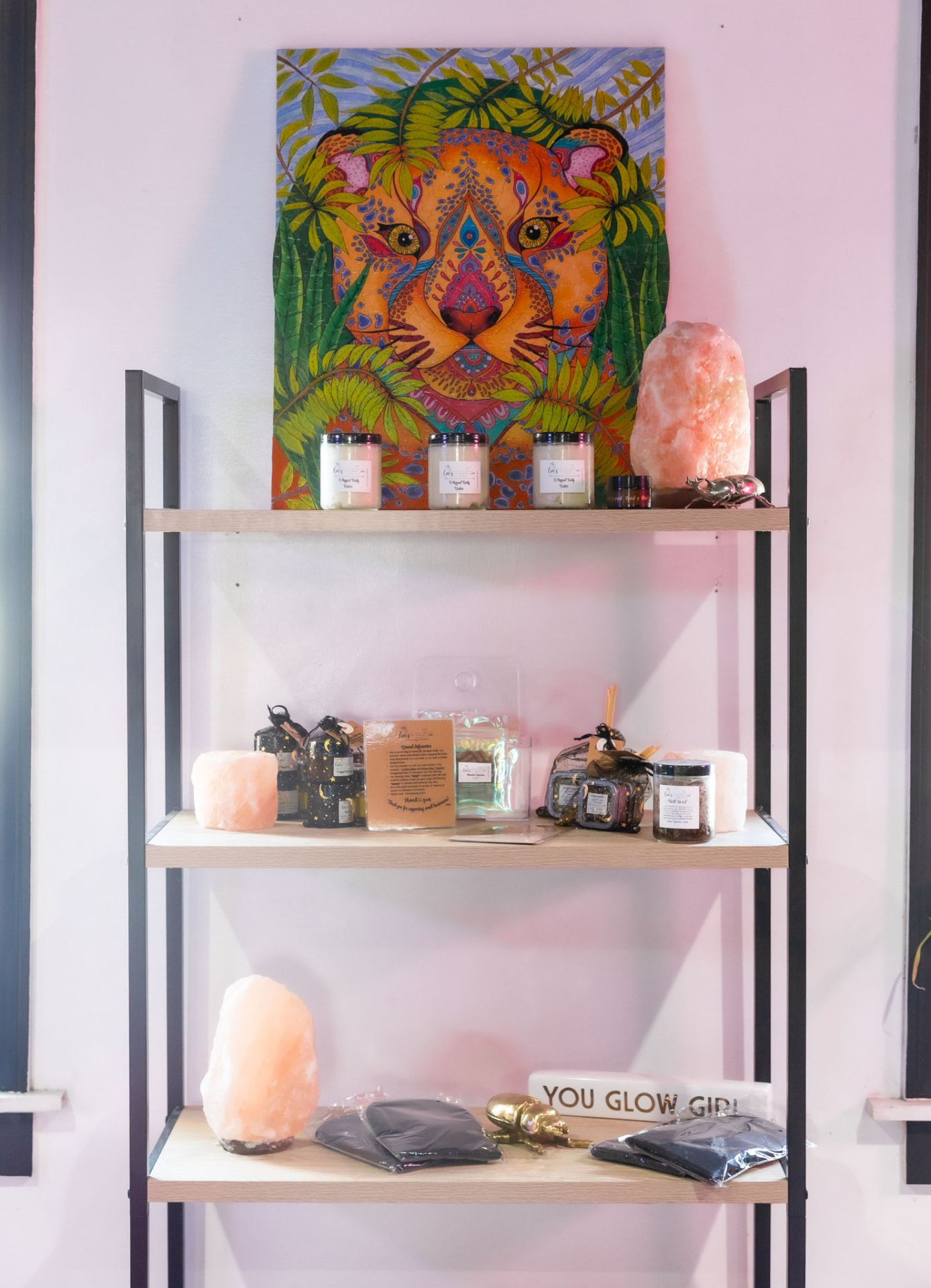 Skincare, candles and self-care products on the retail wall at the Ritual studio